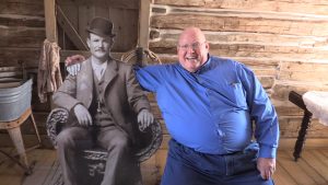 State Parks Director Fred Hayes posing with a cutout of Butch Cassidy.