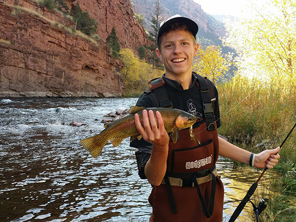 Young man holding a rainbow trout caught at Flaming Gorge Reservoir